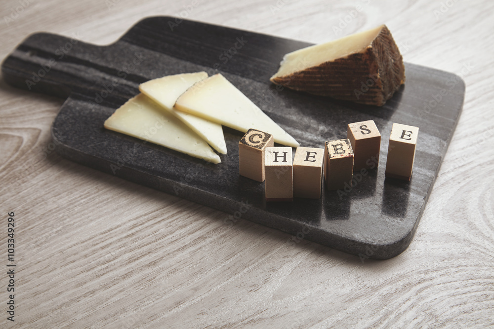 wooden letters side to goat cheese isolated wooden letters side to goat cheese isolated