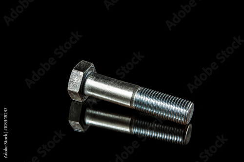 An isolated steel bolt on black background