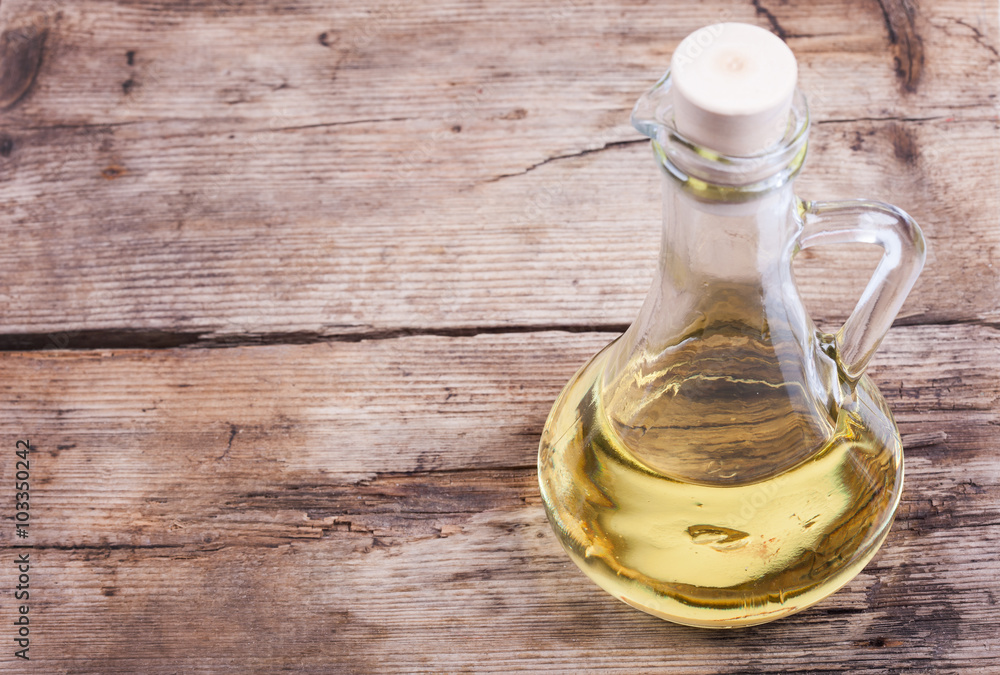 background cooking oil in bottle on wooden rustic table background cooking oil in bottle on wooden rustic table