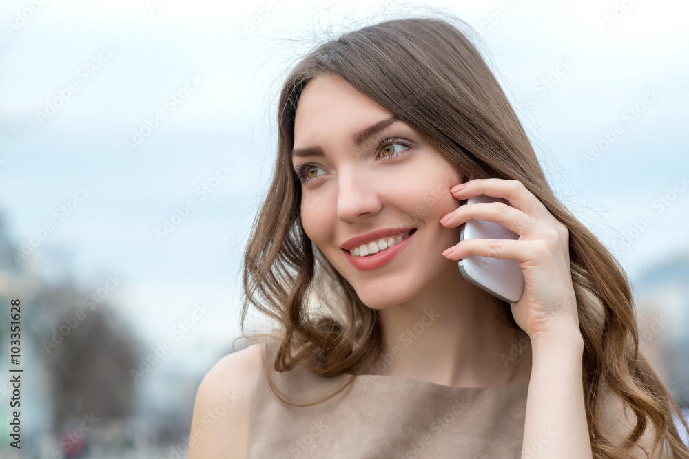 Young beautiful smiling woman talking on cell phone Young beautiful smiling woman talking on cell phone
