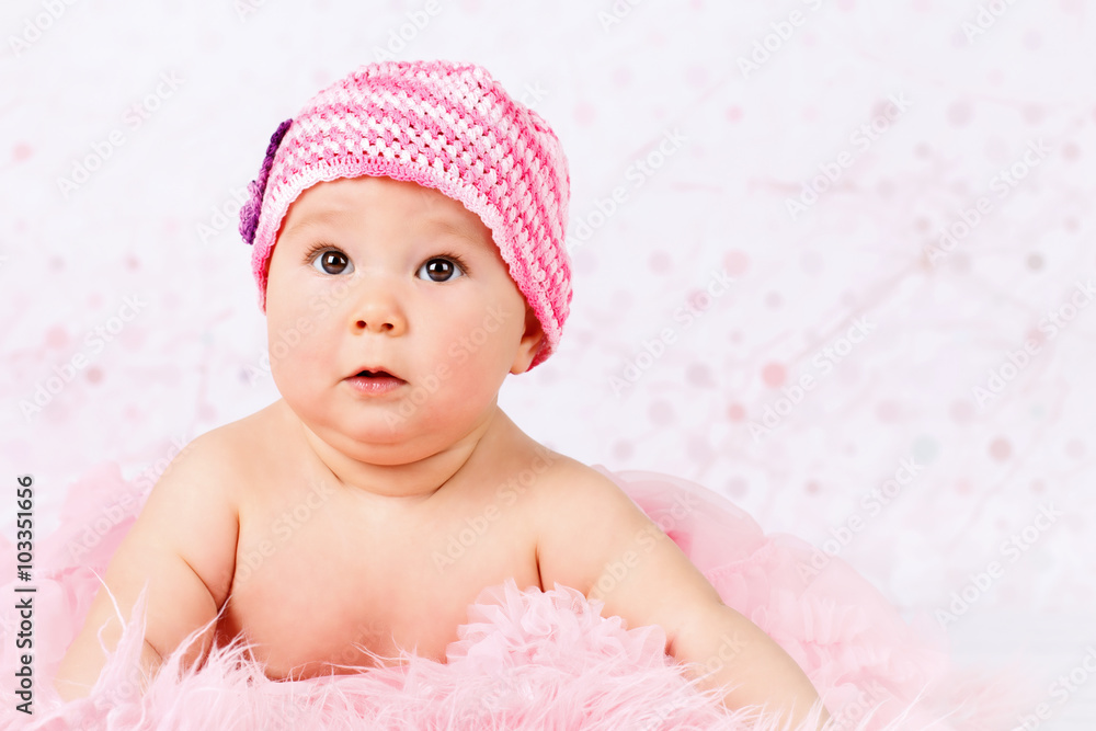 Beautiful little baby girl wearing pink knitted cap Beautiful little baby girl wearing pink knitted cap