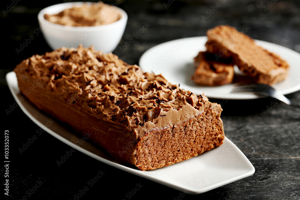 Chocolate cake on a black wooden background Chocolate cake on a black wooden background