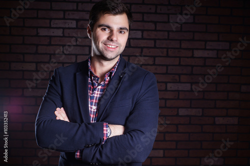 portrait of handsome man in jacket and plaid shirt