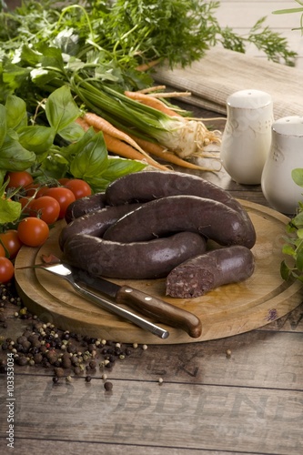 juicy and tasty black pudding on a dark brown planks  photo