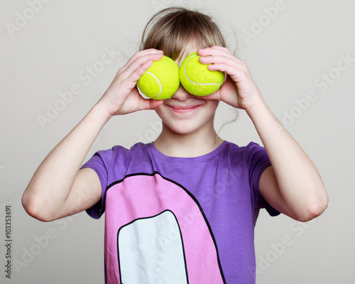 potrtrait of a little girl with tennis balls instead eyes © zdyma4