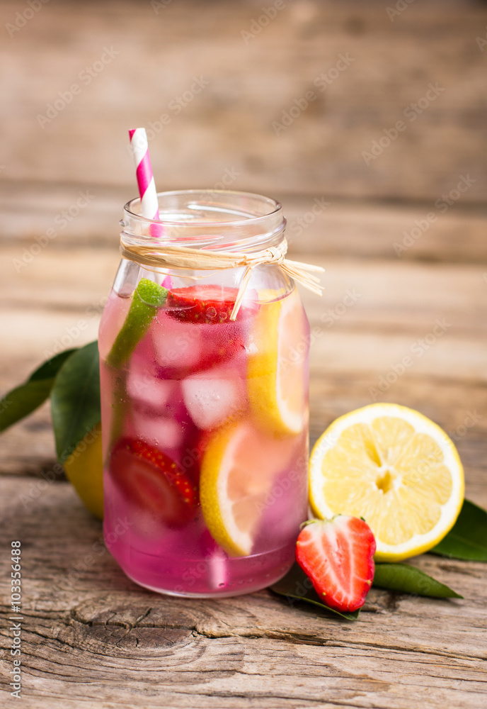 Homemade fresh pink lemonade with lemon, lime and strawberries Homemade fresh pink lemonade with lemon, lime and strawberries