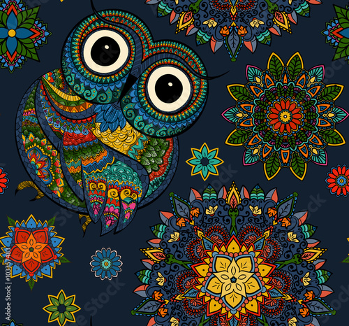 Seamless pattern from ornamental color owl with flowers and mandala. African, indian, totem, tattoo design. It may be used for design of a t-shirt, bag, postcard, a poster and so on.