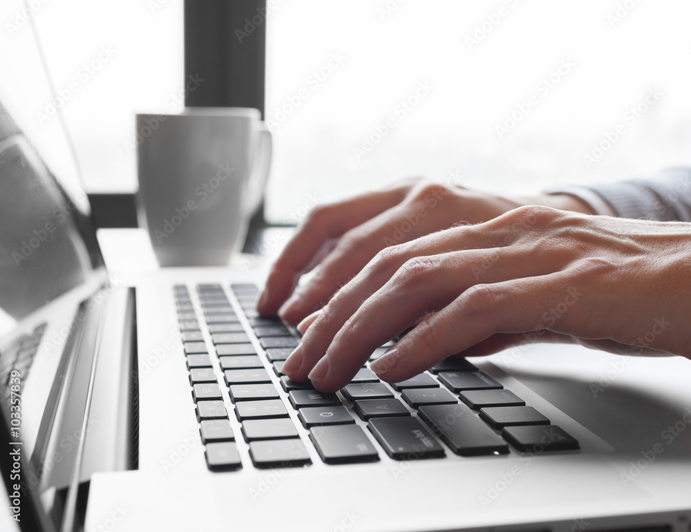 © kieferpix - Closeup of businesswoman typing on laptop computer