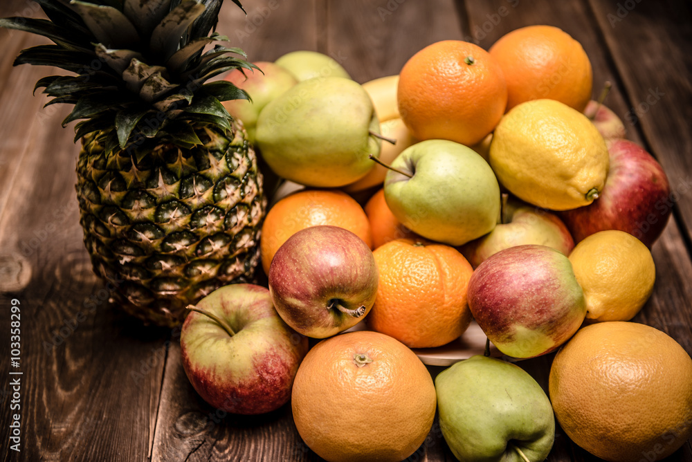 Tasty fruit background with orange, apples and banana on the wooden boards table Tasty fruit background with orange, apples and banana on the wooden boards table