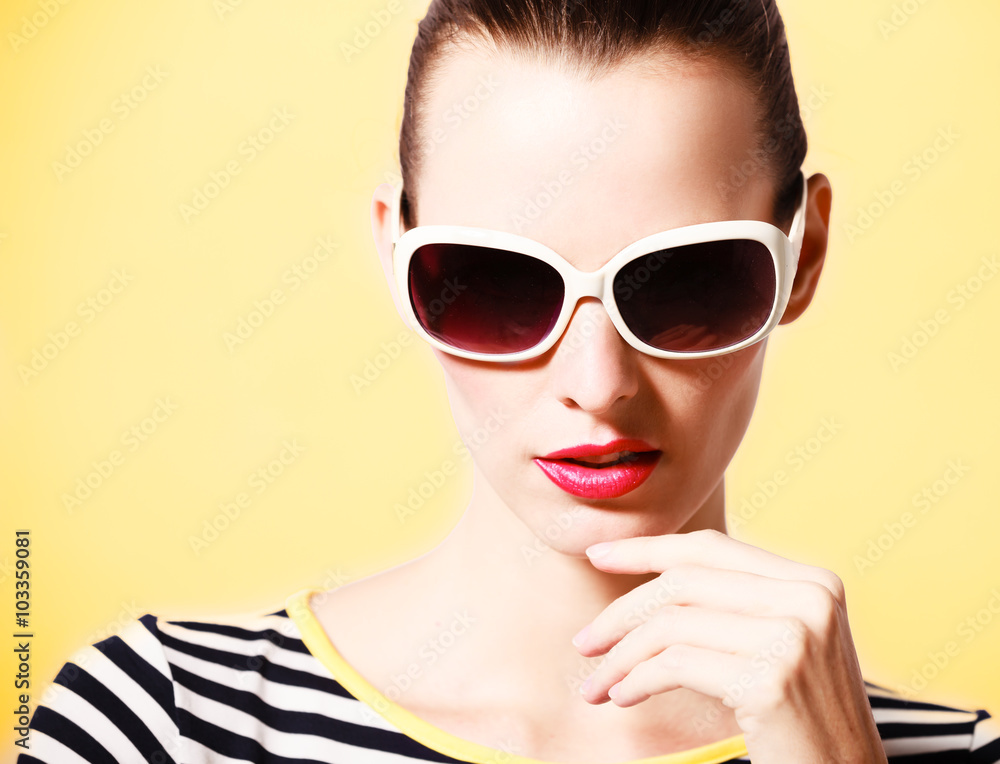 Fashion model striking a pose wearing sunglasses.
Fashion model striking a pose wearing sunglasses.