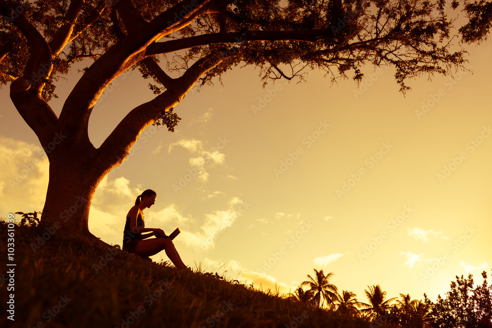 Woman working on her computer in the park. 