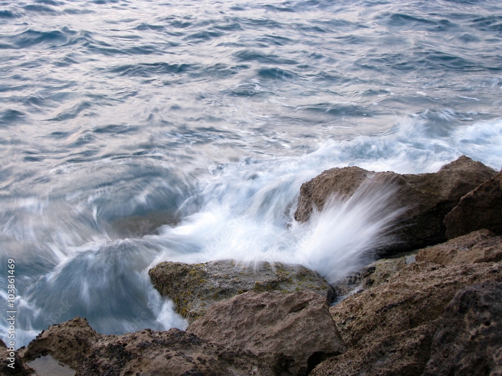 Stones and sea wave splashes