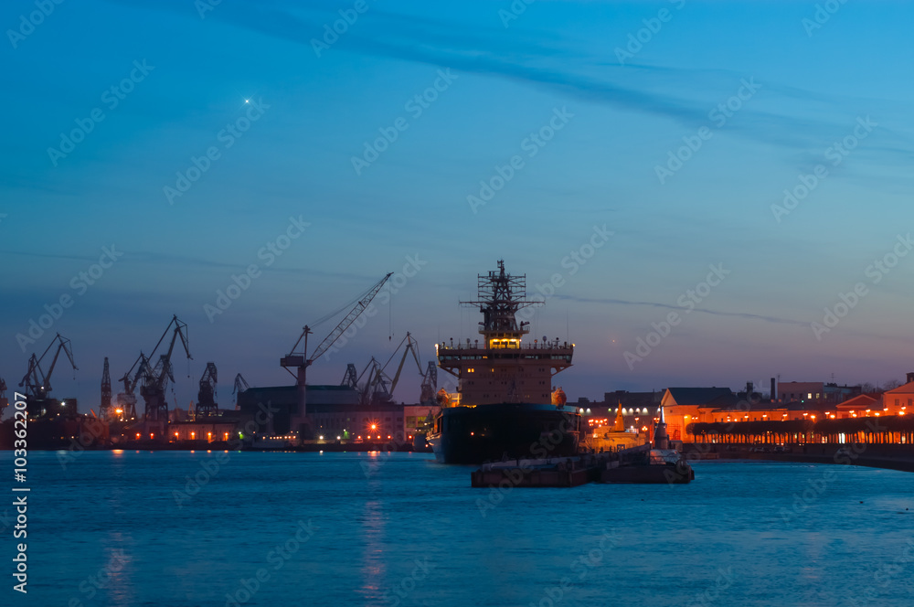 The view of city port and water, illuminated. White night