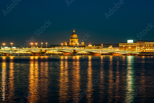 View of English embankment, St. Isaac's Cathedral and Annunciation bridge in St. Petersburg with night illumination © fotoizba