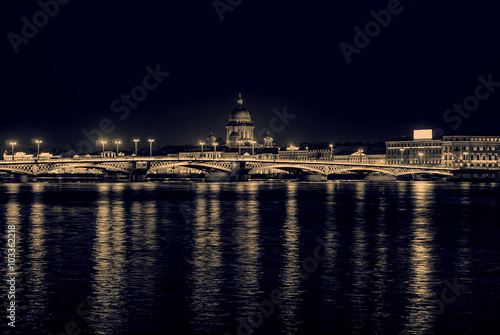 Night view of the English embankment, St. Isaac's Cathedral and Annunciation bridge in St. Petersburg, monochrome retro effect