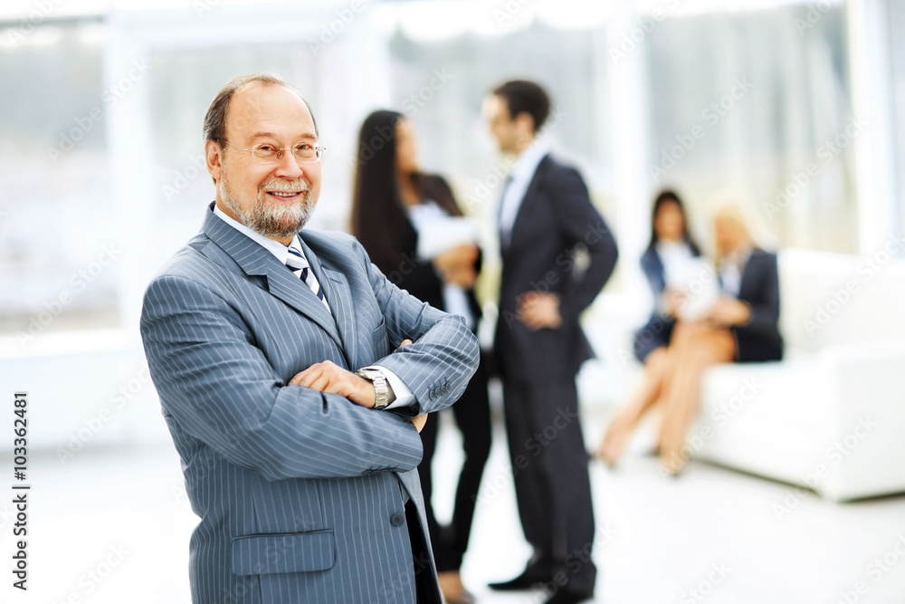 portrait of a successful businessman on background of office portrait of a successful businessman on background of office