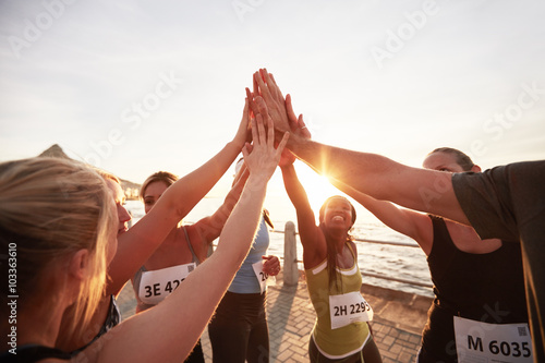 Marathon runners giving high five