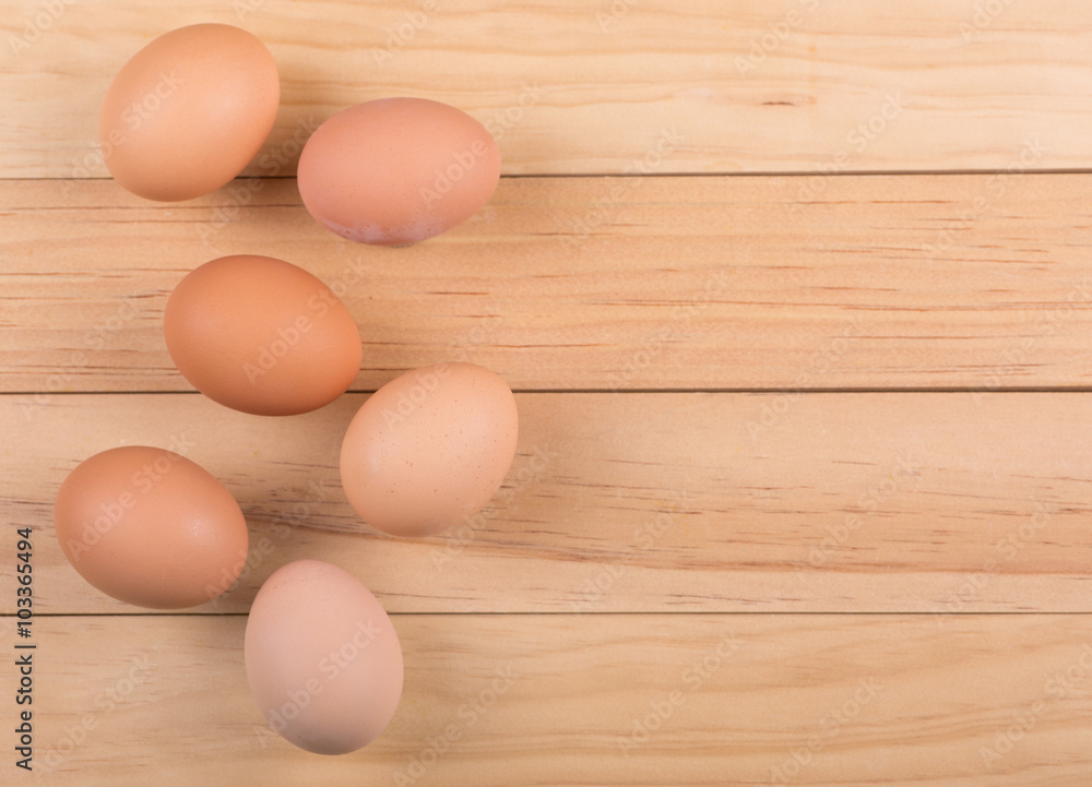 Group of Brown Eggs on a Wooden Surface Group of Brown Eggs on a Wooden Surface