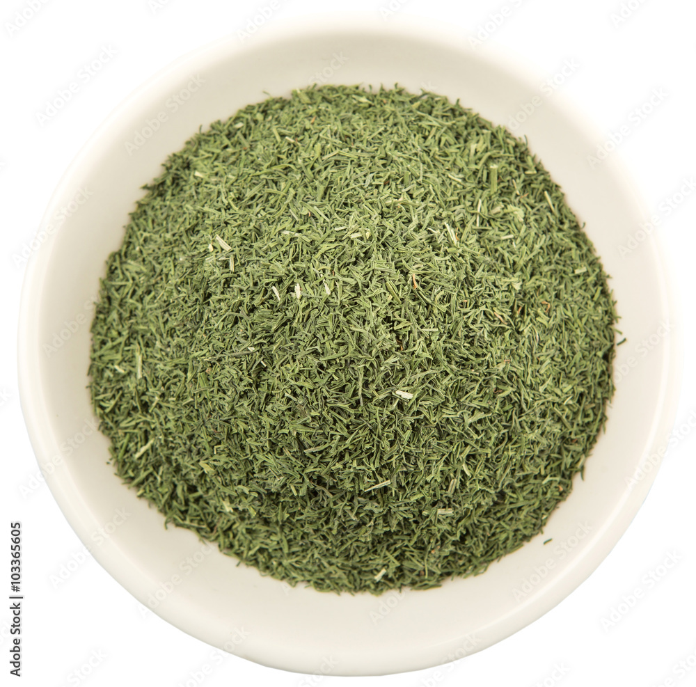 Dried dill herbs in white bowl over white background Dried dill herbs in white bowl over white background