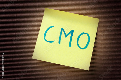 CMO (Chief Marketing Officer) acronym on yellow sticky note