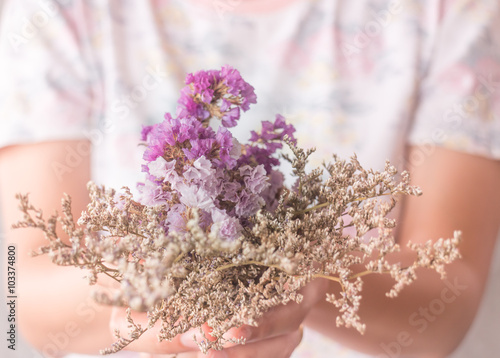 Hand on beautiful dried flower