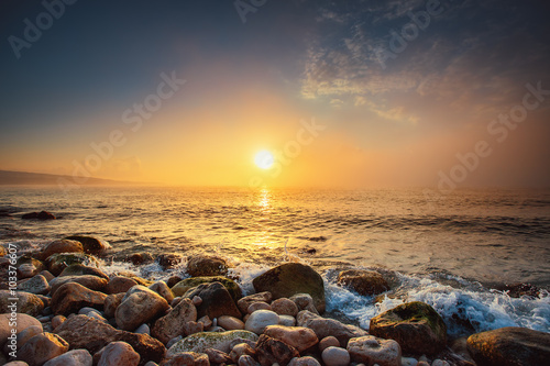 Tropical colorful sunrise at the stones beach. © ValentinValkov