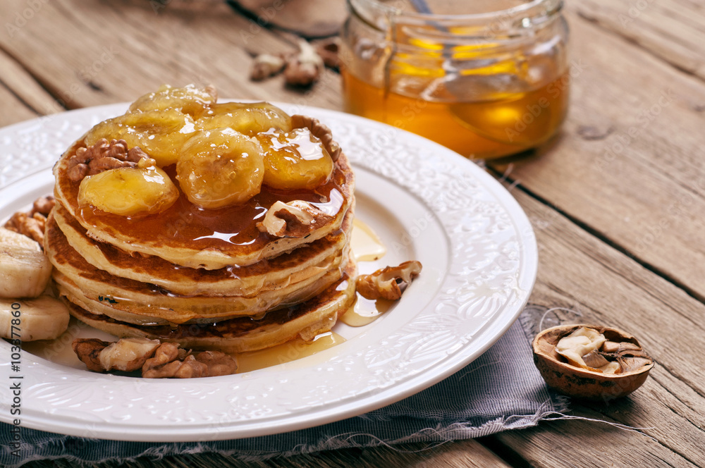 healthy breakfast of pancakes with honey, nuts and caramelized b healthy breakfast of pancakes with honey, nuts and caramelized b