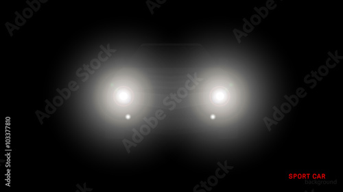 Silhouette of car with headlights on black background
