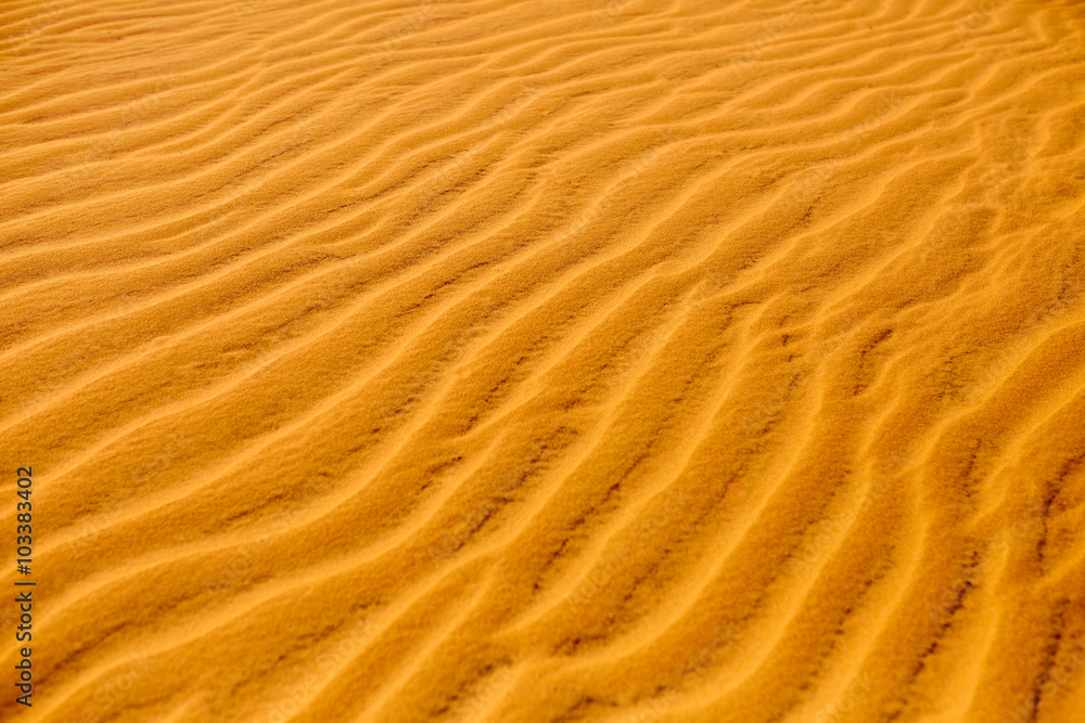 Sand Texture Background. Close up view of orange ripple sand pattern of dunes in desert. Nature elements details. Sand Texture Background. Close up view of orange ripple sand pattern of dunes in desert. Nature elements details.