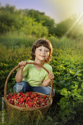 cheerful boy with basket of berries
