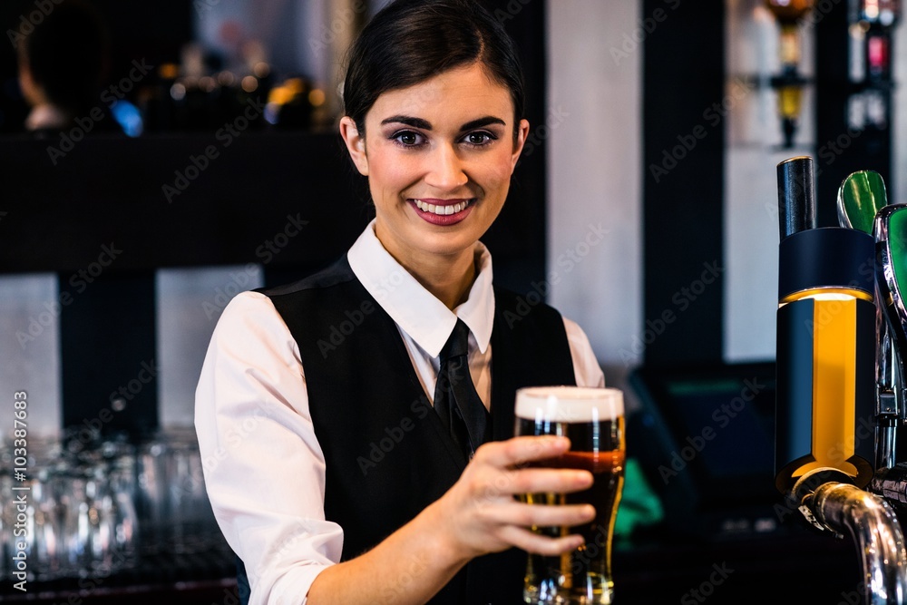 Barmaid serving a pint
