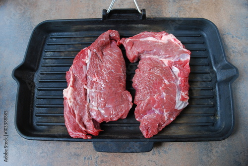 Fresh beef steak on a grill.