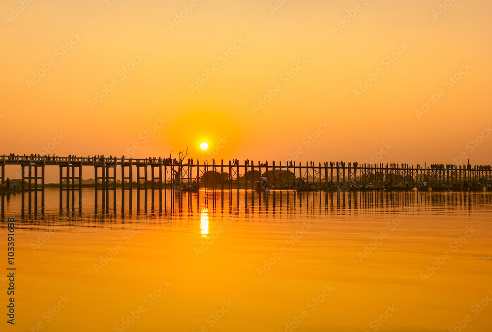 Evening time, sunset at oldest teakwood bridge before getting dark, Amarapura lake, Mandalay, Myanmar 