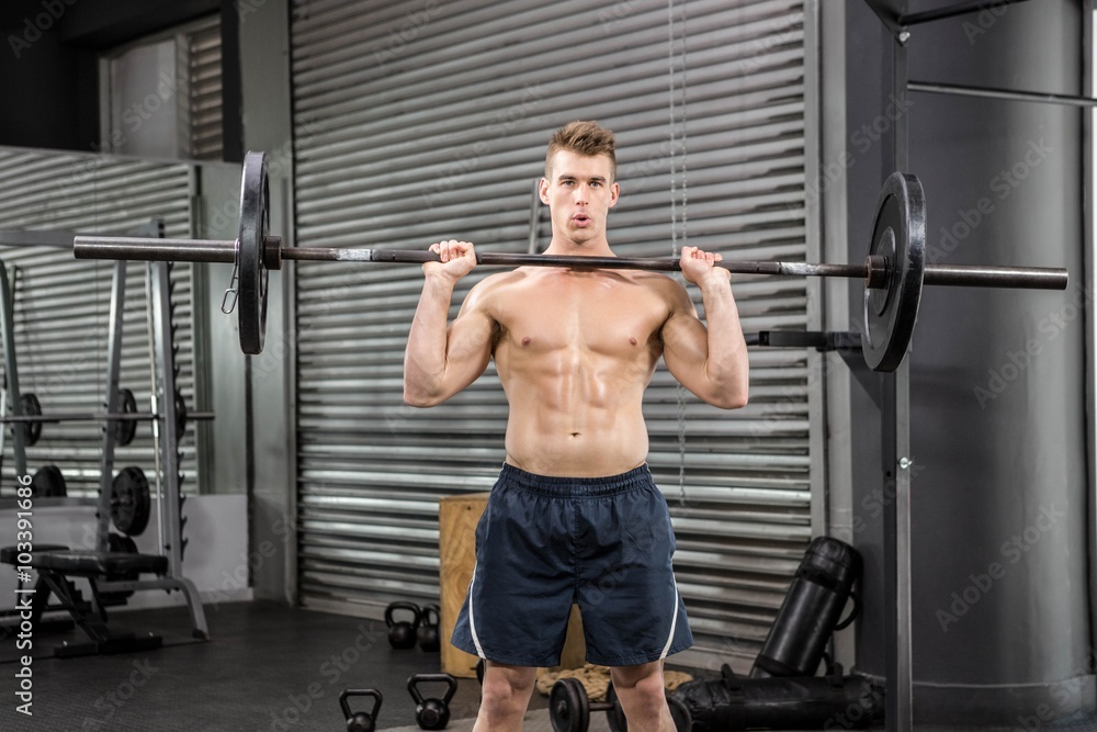 Shirtless man lifting barbell Shirtless man lifting barbell