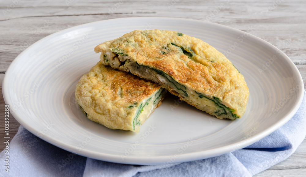 Omelet with spinach on plate