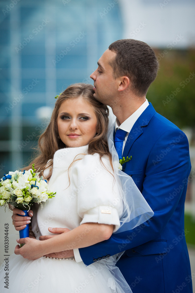 gorgeous happy brunette bride and elegant groom in blue suit wit gorgeous happy brunette bride and elegant groom in blue suit wit