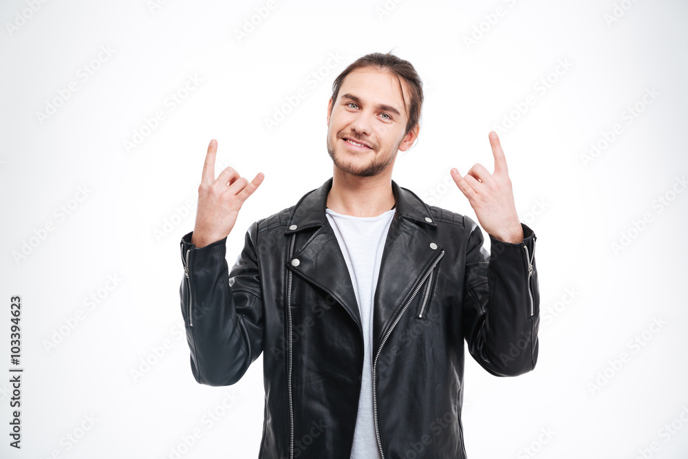 Smiling handsome man in black leather jacket doing rock gesture Smiling handsome man in black leather jacket doing rock gesture