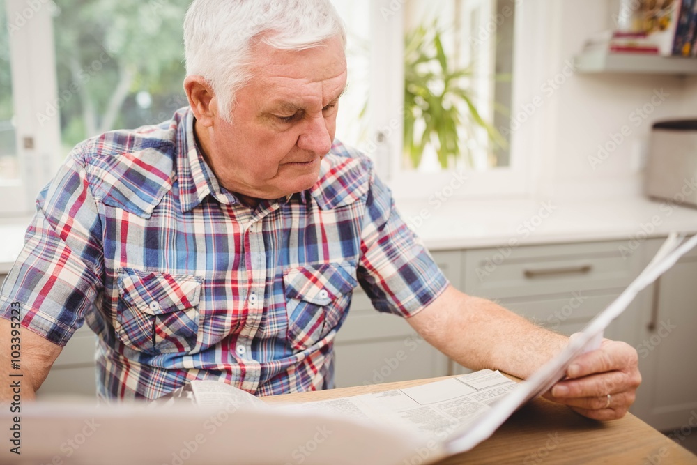 Senior man reading a newspaper Senior man reading a newspaper