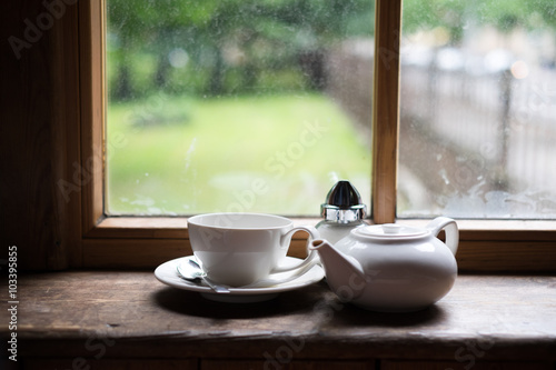 Tea cup pot and sugar on wood table