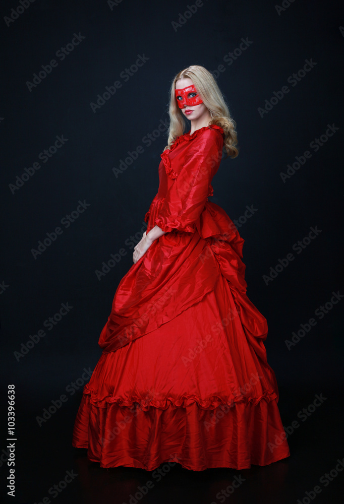 full length portrait of a beautiful blonde woman wearing a historical red silk, victorian era ball gown. full length portrait of a beautiful blonde woman wearing a historical red silk, victorian era ball gown.