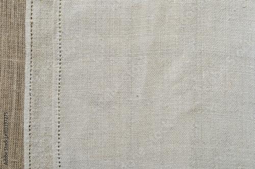 Tableau sur toile Background of the ancient homespun fabric with a handmade hem