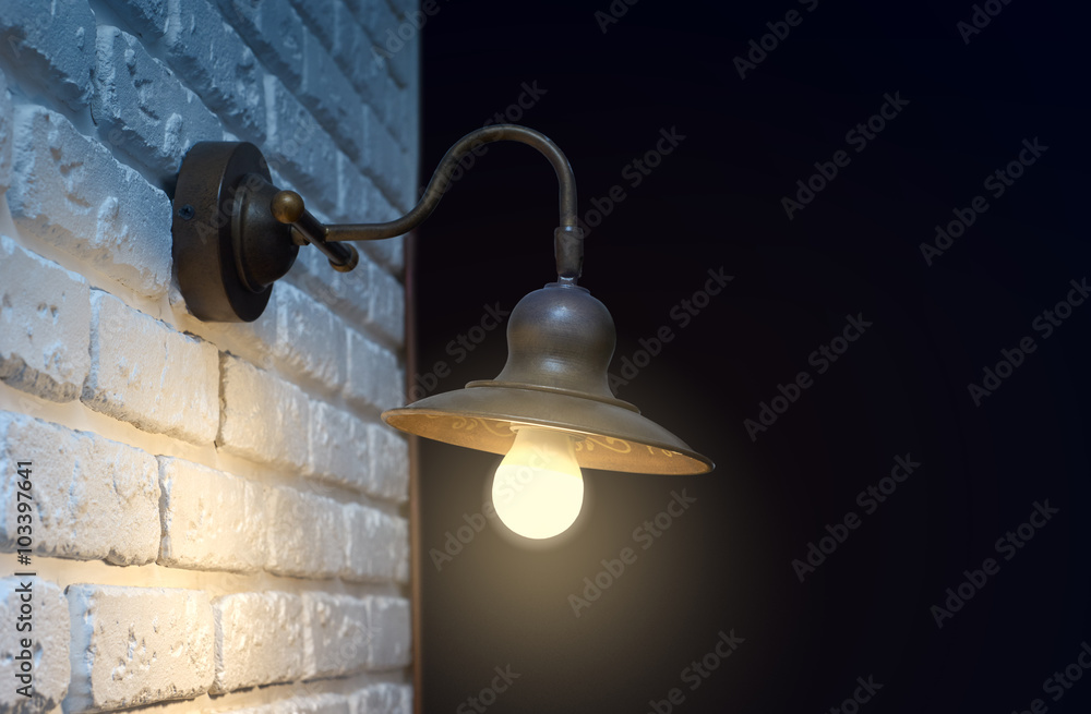 Obraz premium Lantern on a brick wall