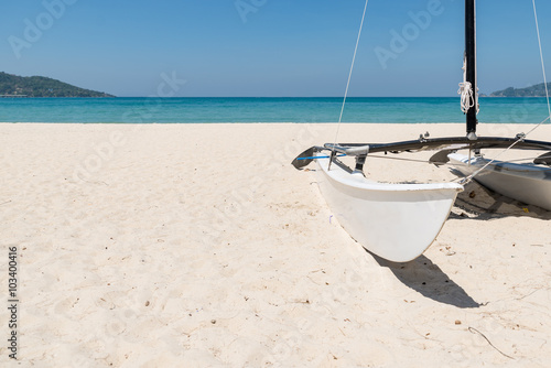 sailboat on white sand beach in summer clear blue sky with copy space