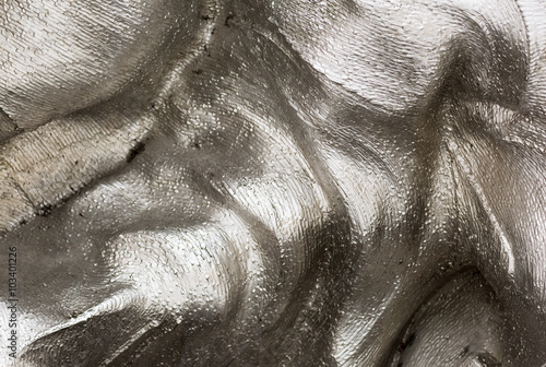 Background texture of the shining metal surface. The curved plate is made of iron.