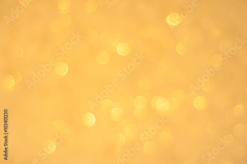 Gold glittering christmas lights. Blurred abstract background