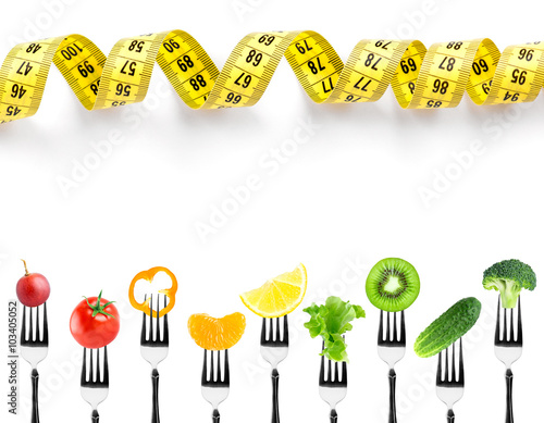 Fruits and vegetables on fork with measuring tape