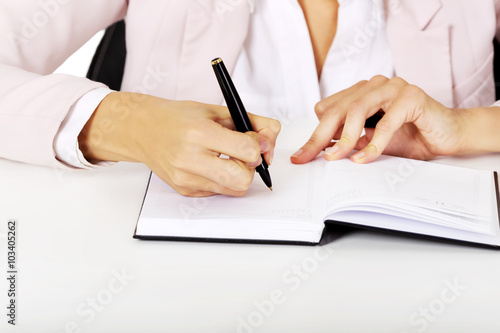 Closeup photo of female hand writing notes