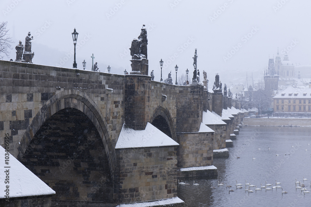 Snowy foggy Prague Charles Bridge with its baroque Sculptures, Czech Republic