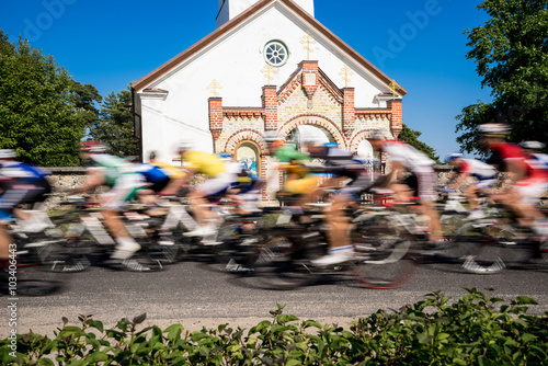 Cyclists  sports day, Orthodox Church in the background. Kihnu, small island in Estonia. Europe photo