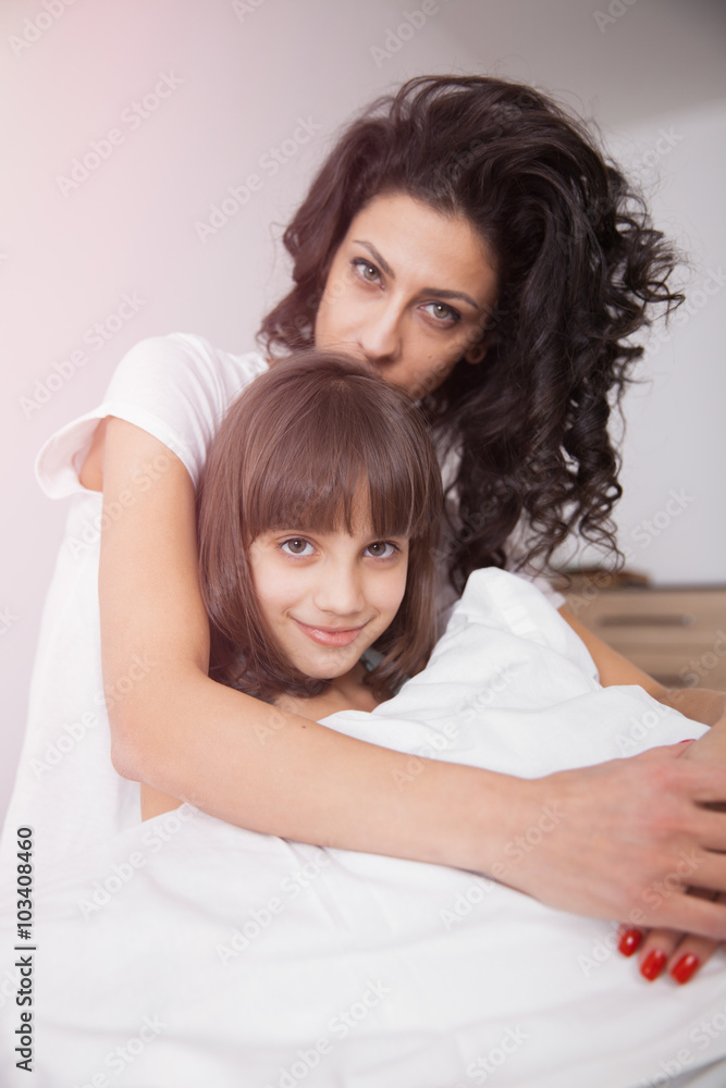 Long hair mother and daugther on the bed Long hair mother and daugther on the bed